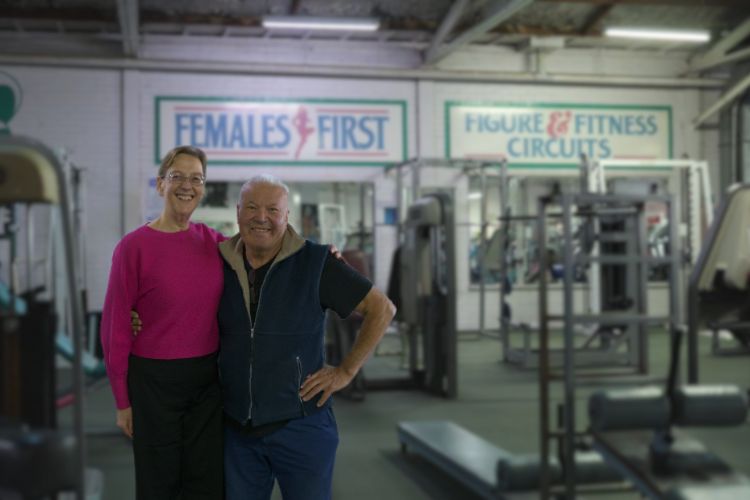 Vicky and Laurie smile together in Supershape Gym, showcasing a supportive community atmosphere.